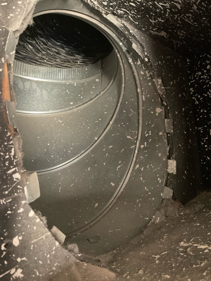 Interior of duct with dust and debris accumulation before cleaning