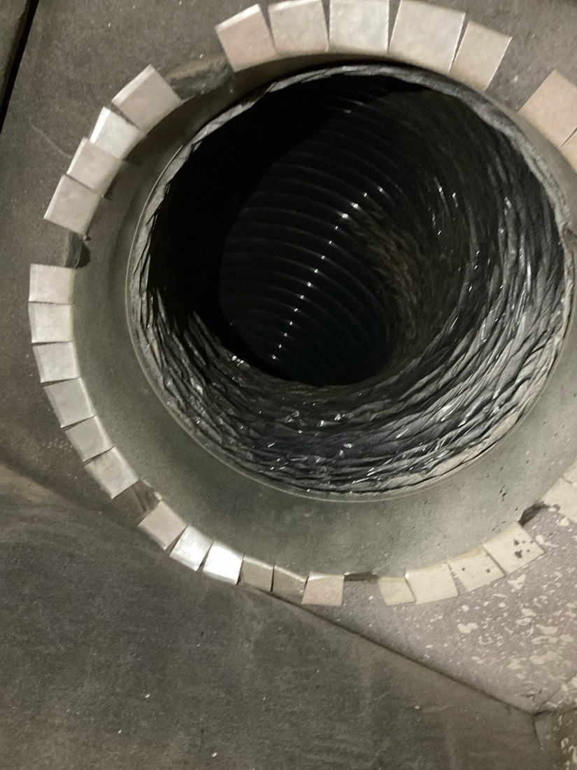 Clean flexible ductwork interior showing curved metal ridges after air duct cleaning.