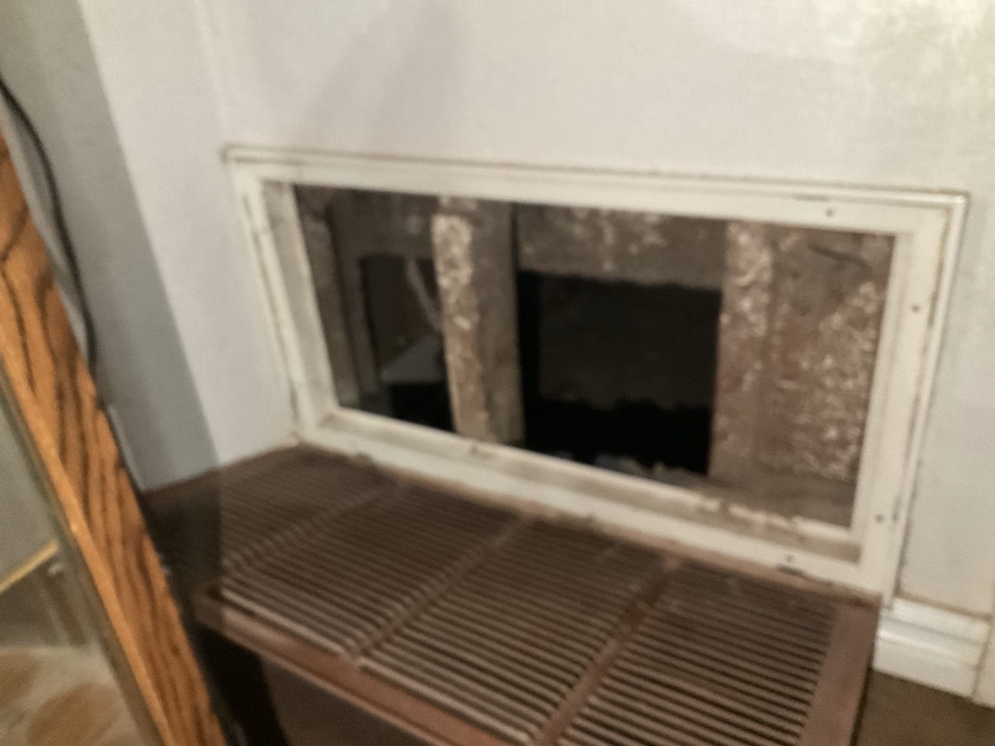 Clean return air intake grill in basement wall