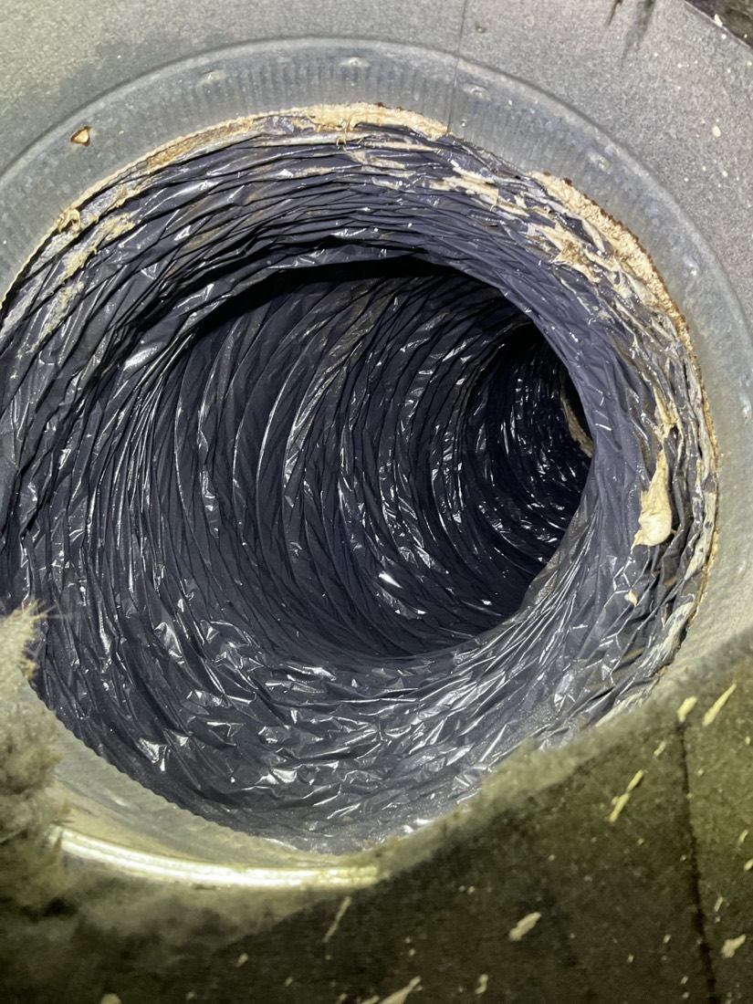 Ductwork interior with dust and debris during cleaning