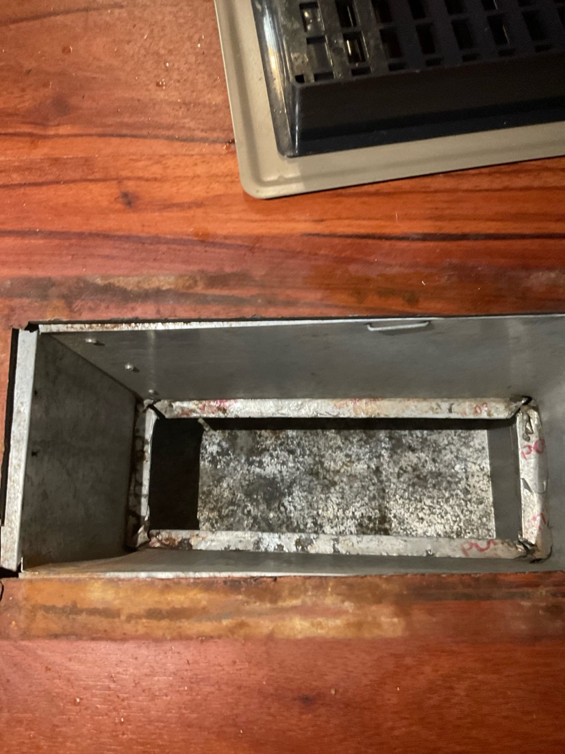Interior view of ductwork with visible dust accumulation before cleaning.