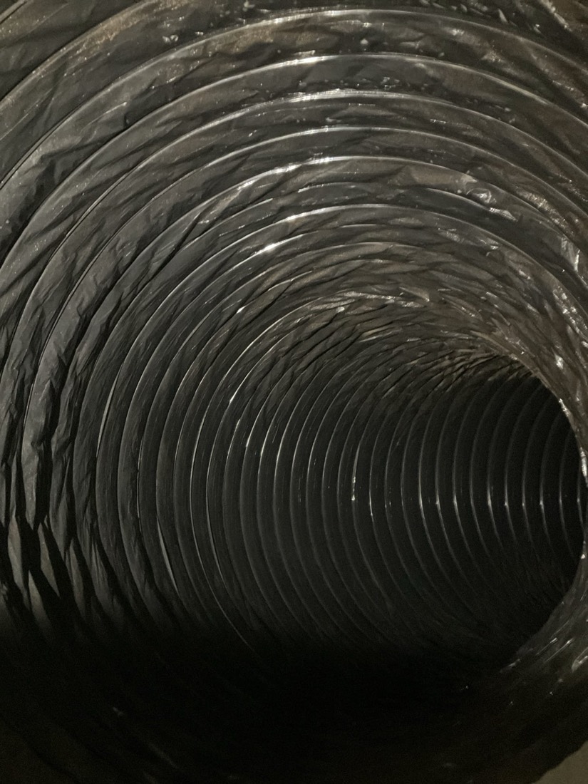Clean flexible air duct interior showing metal coils.