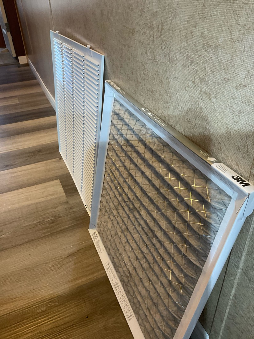 Two air filters side by side comparing clean and dirty HVAC filters
