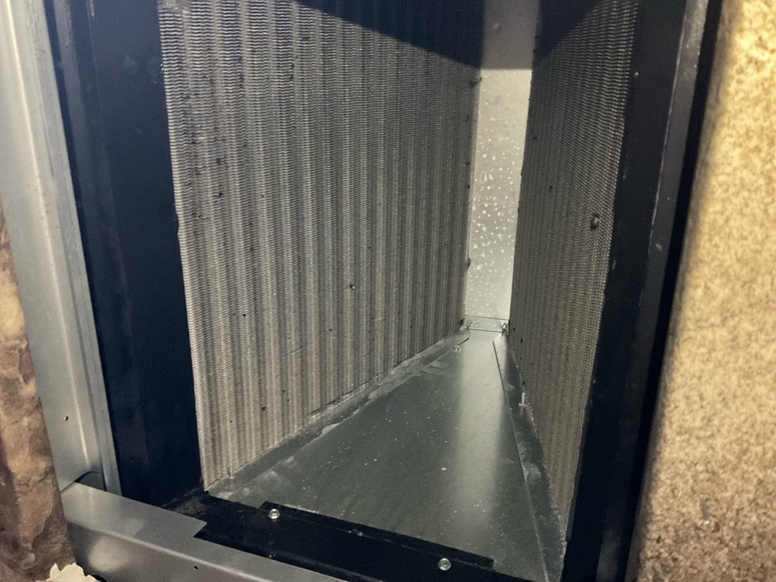 Clean pleated air filter installed in ductwork system