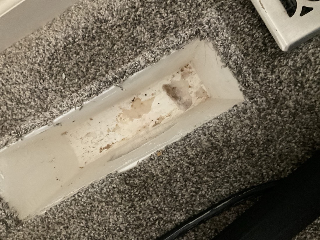 Air duct after cleaning, appearing significantly cleaner with most debris removed.