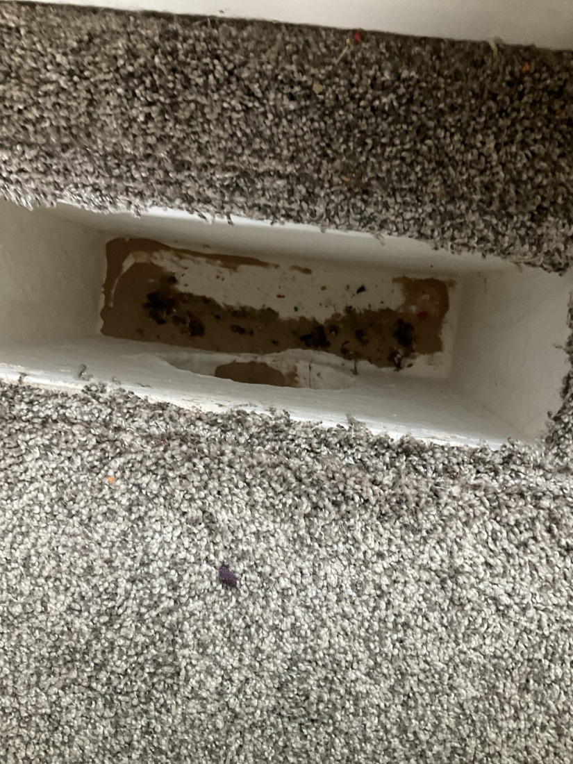 Dirty air duct with heavy debris and dust accumulation visible.