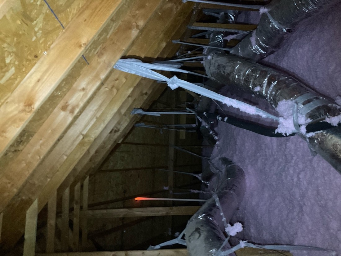 Attic insulation with vertical supports properly secured