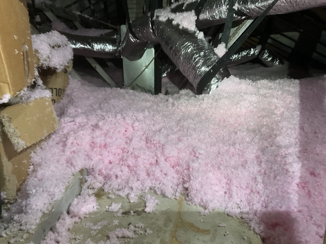 Pink fiberglass batts installed in attic joists