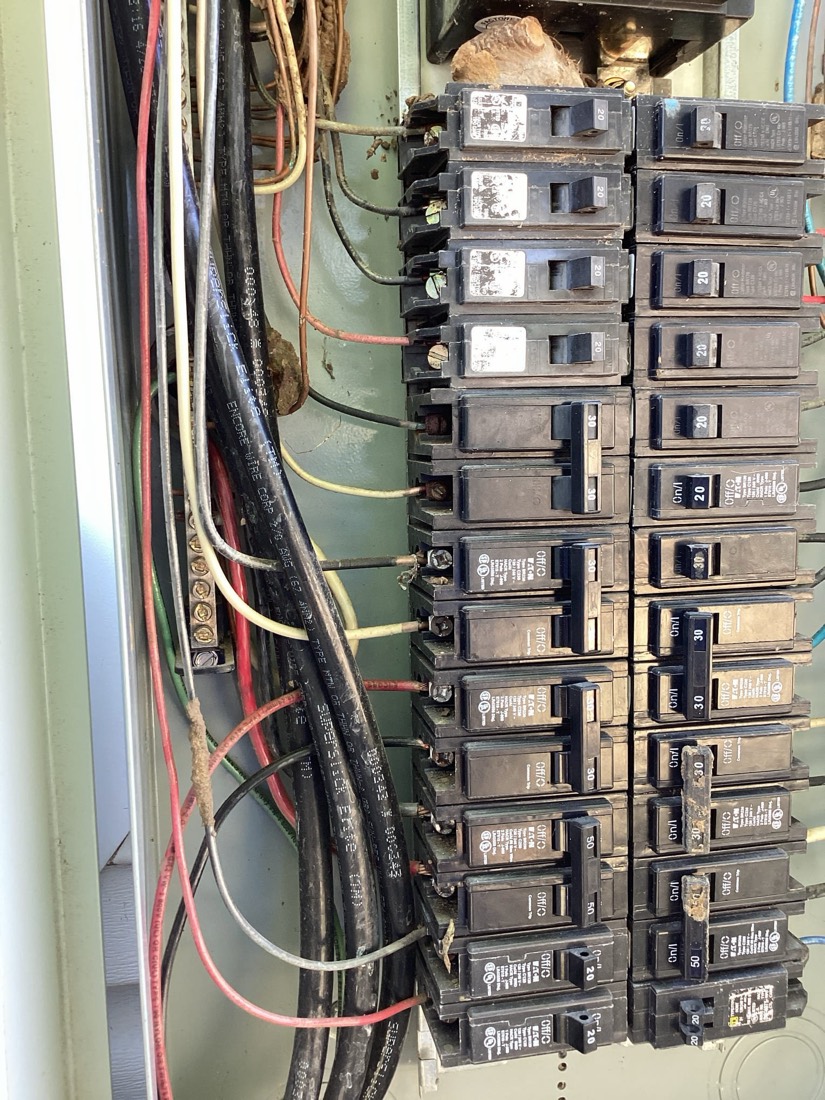 Main electrical panel with neatly organized breakers and labeled color-coded wires.