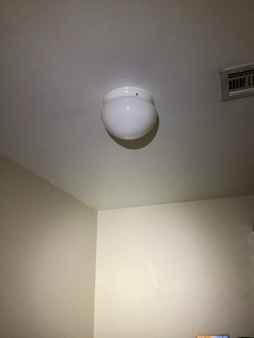 Installed LED ceiling light fixture mounted on drywall.