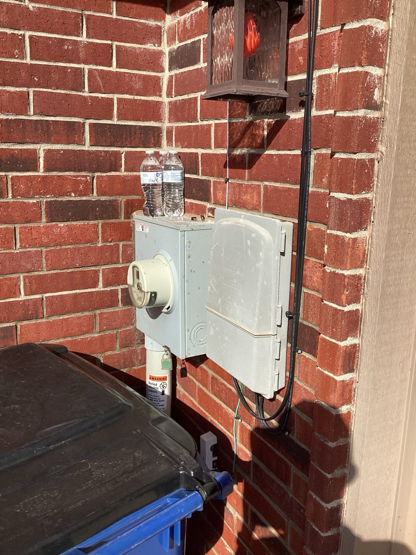 Outdoor electrical disconnect switch on brick wall
