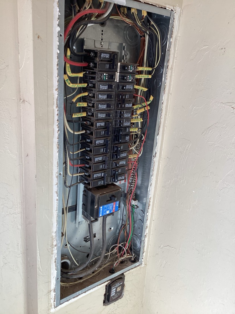 Newly installed electrical panel with organized breakers and labeled wiring