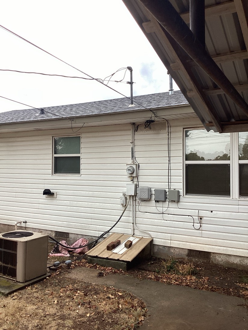 New electrical service installation with meter box, conduit, and outdoor wiring
