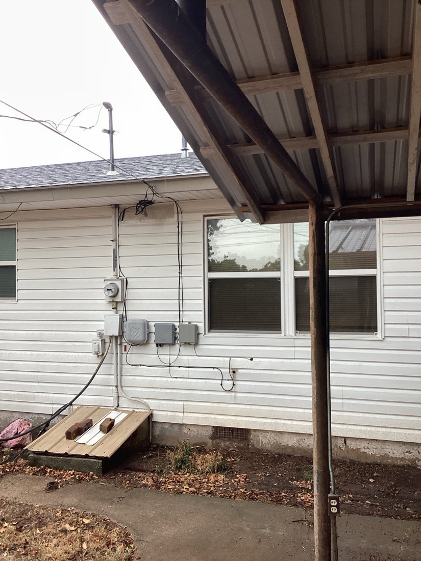 Exterior electrical service installation with new conduit and meter setup