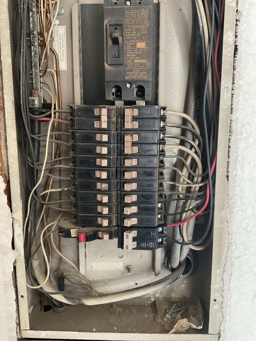 Main electrical panel with breakers and wiring connections inspected during service.