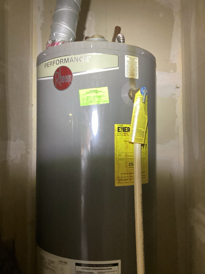 Performance water heater with vent pipe installed in utility space