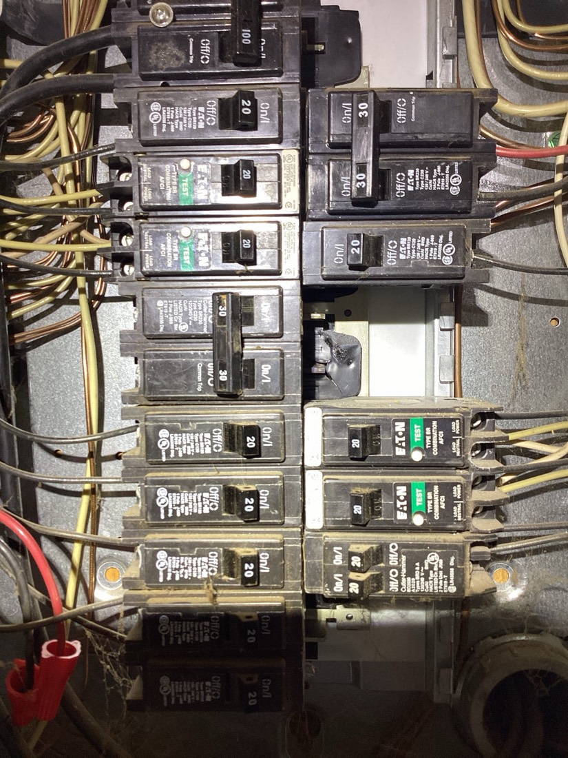 Organized electrical panel with labeled circuit breakers and wiring