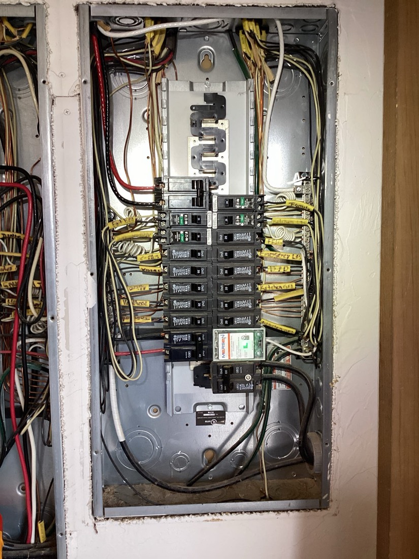 Installed electrical panel with organized sub-breakers