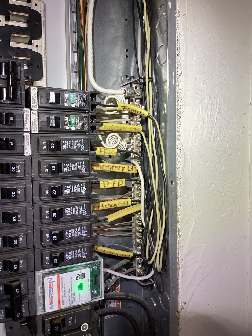 New electrical sub-panel with organized breakers and labeled wires