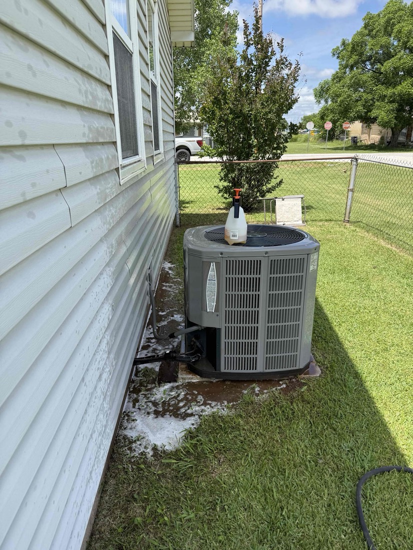 AC condenser unit next to house exterior