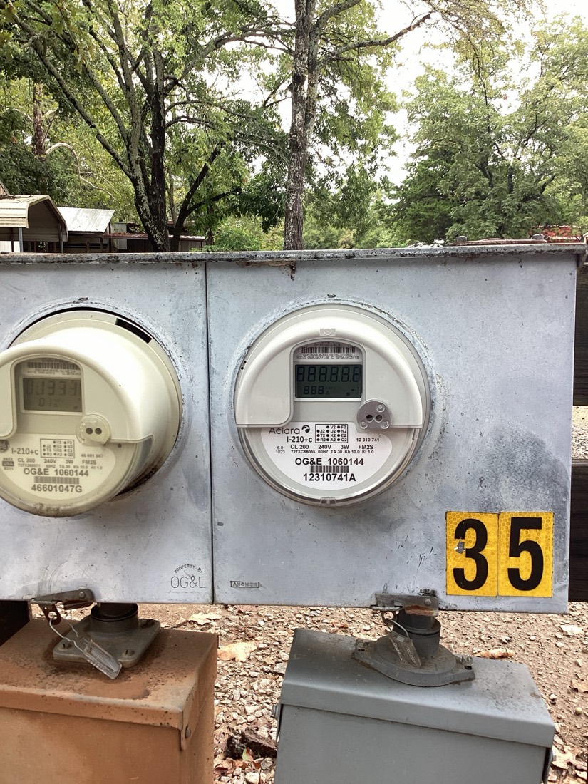 Two electrical meters mounted side-by-side on exterior panel