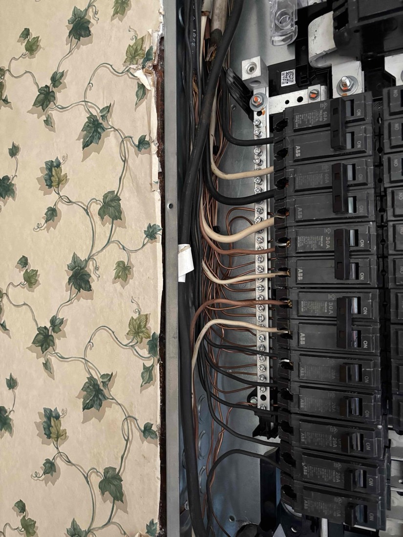 Neatly organized electrical wiring on breaker panel installation.