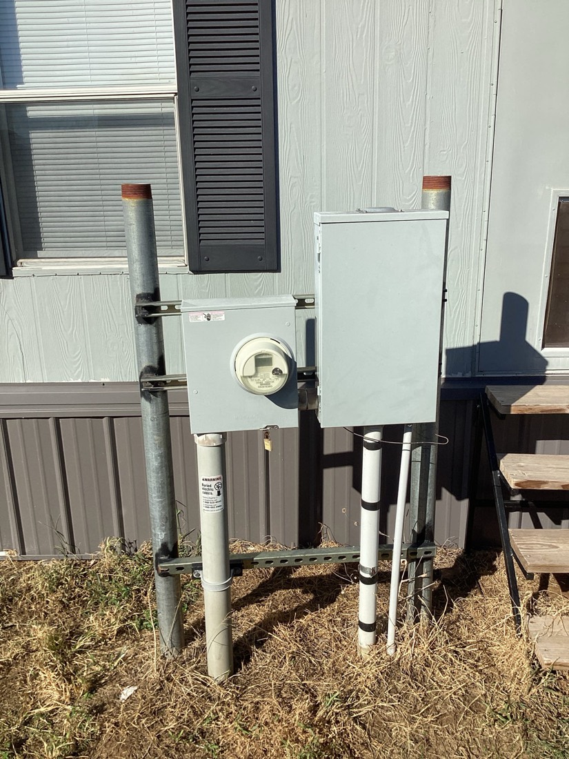 Electrical meter and disconnect box mounted on metal pedestal