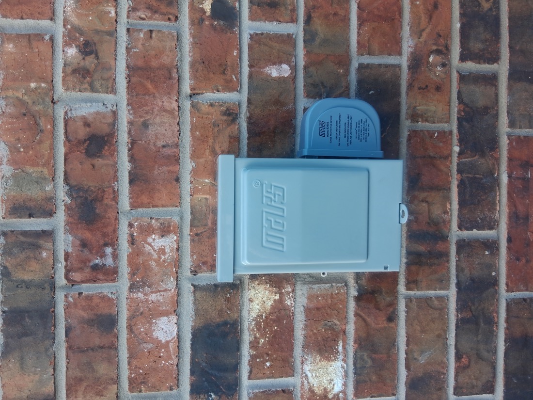 Electrical disconnect switch mounted on brick wall