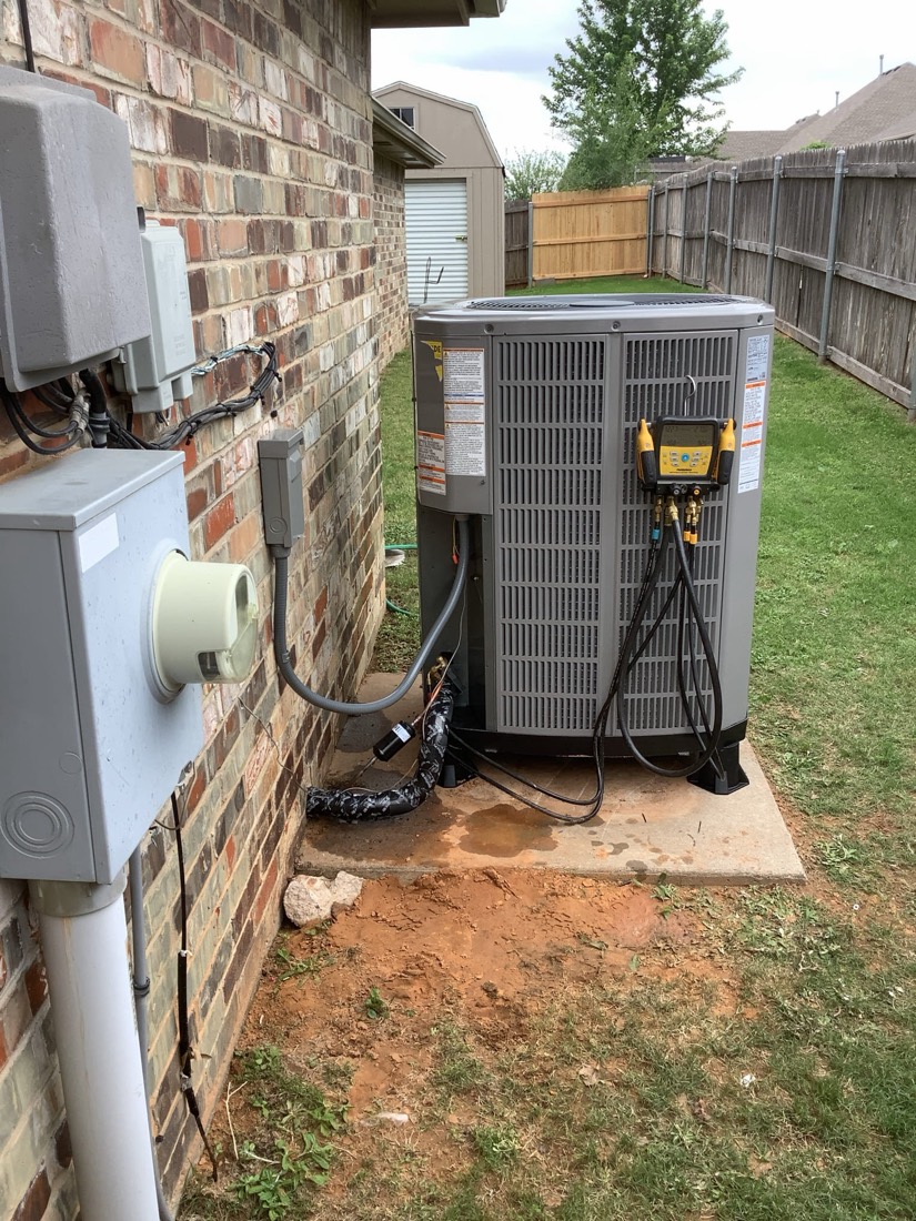 New outdoor AC unit installed with indoor air handler unit visible