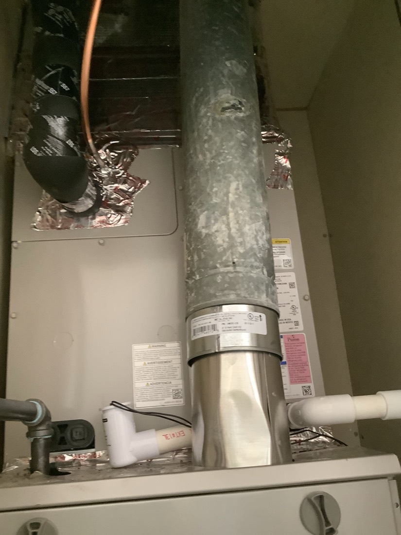 Installed furnace with metal ductwork and refrigerant lines