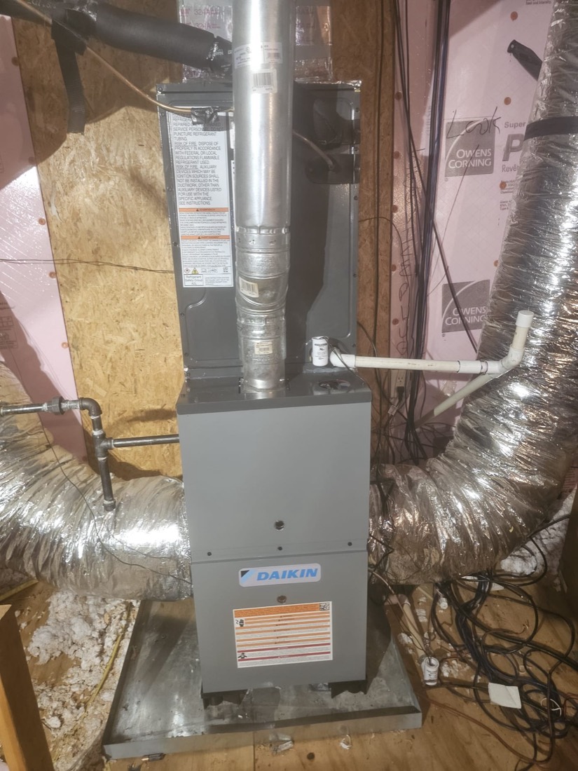 Daikin furnace installation with connected ductwork in basement.