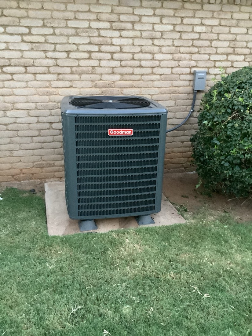 Installed Goodman AC condenser unit on proper concrete foundation pad