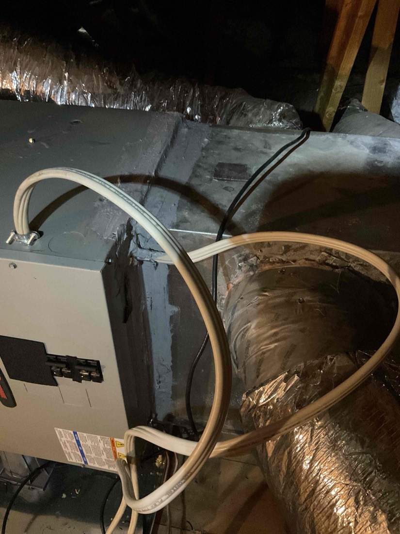 Humidifier unit connected to HVAC plenum with copper line.