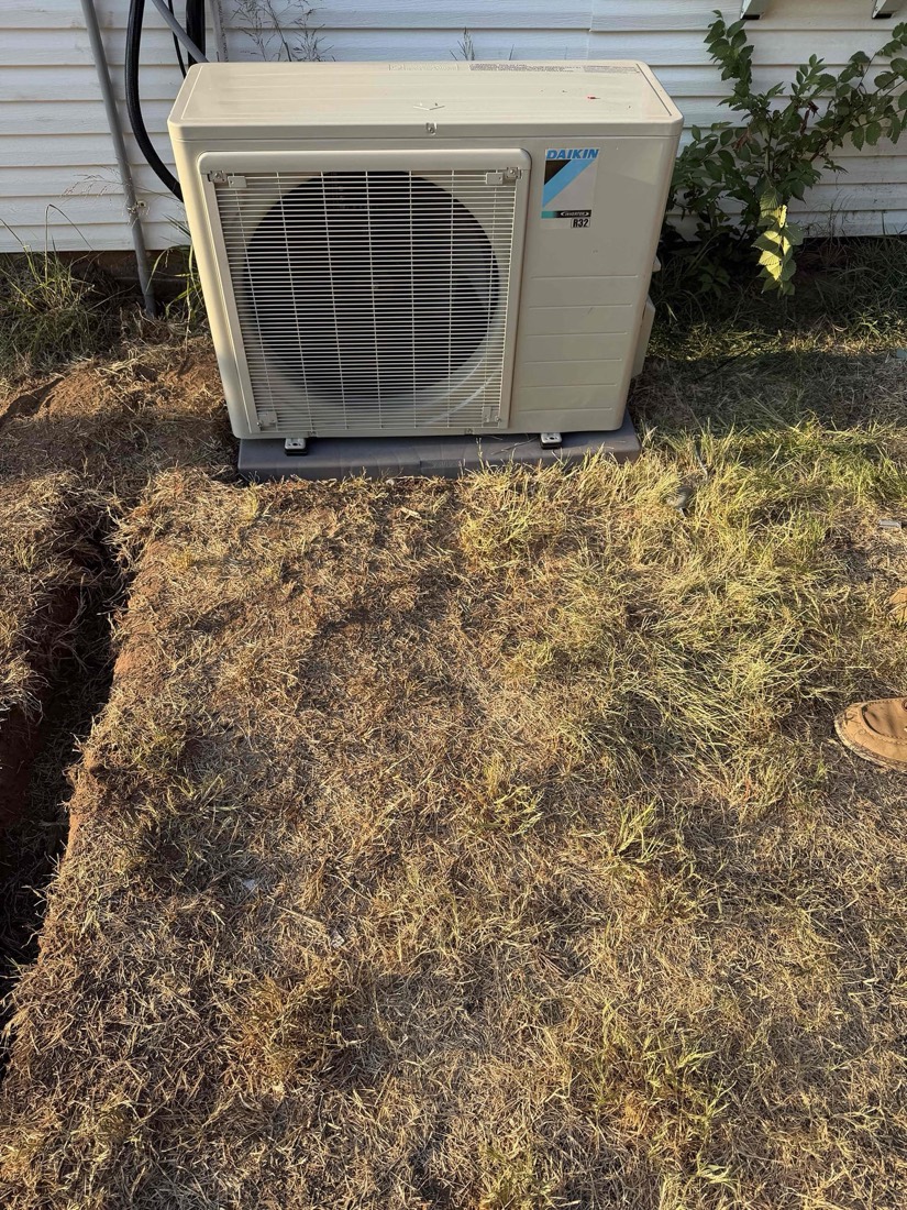 Installed Daikin AC condenser unit on ground next to house in Jones, OK