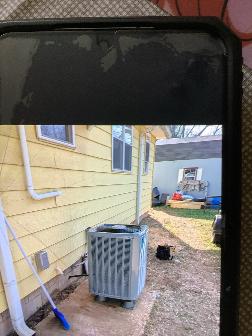 Installed AC condenser unit in exterior service area.