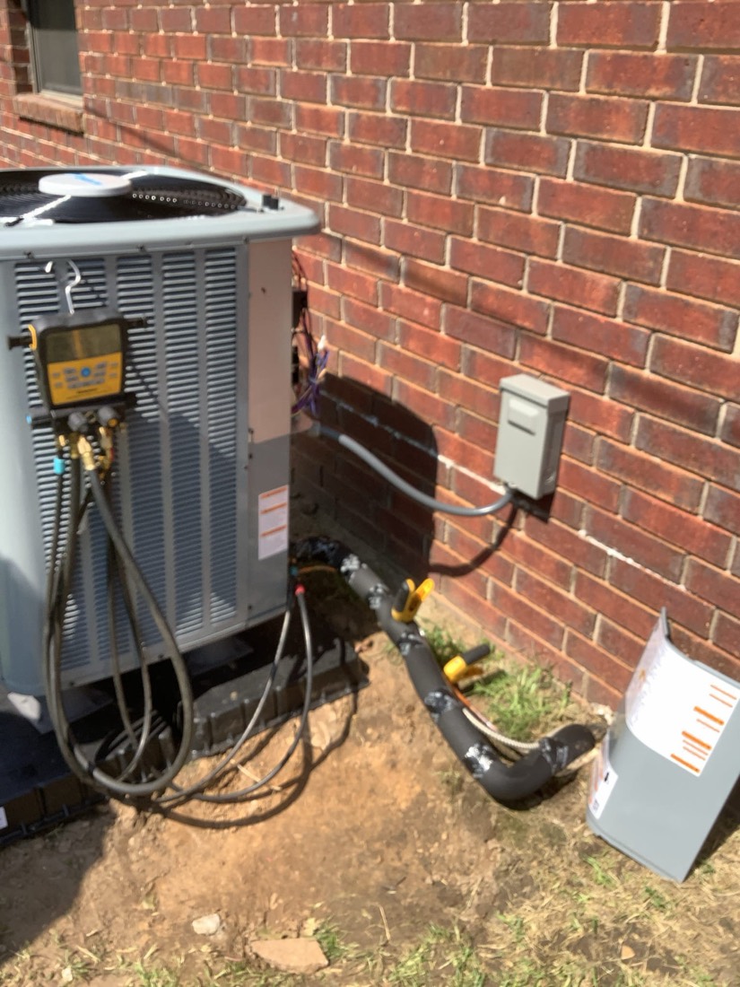 AC condenser unit with connected refrigerant lines