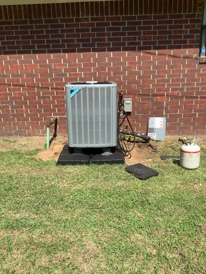Installed AC condenser unit with lines and disconnect