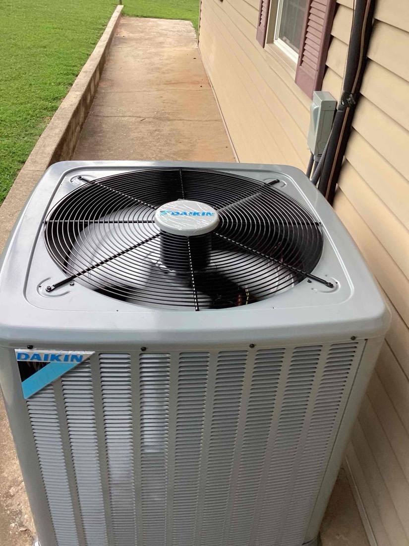 Daikin AC condenser unit with fan installed on pad