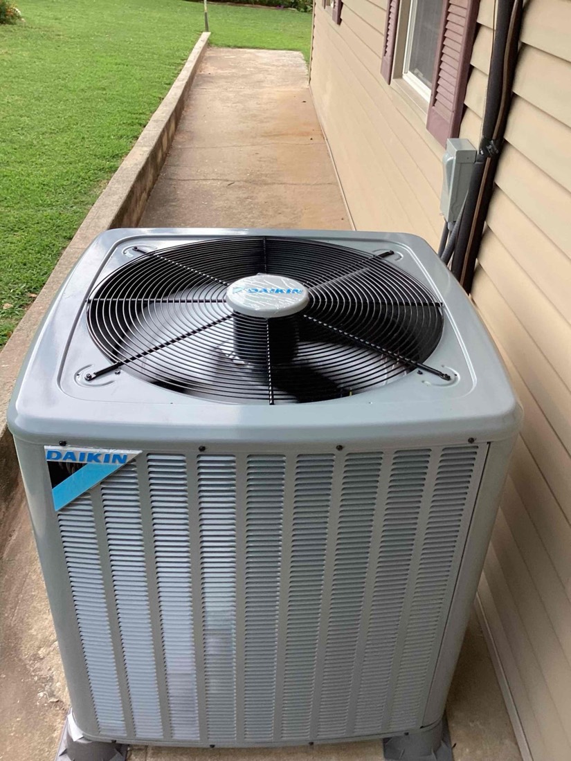 Daikin AC condenser unit with fan installed on pad