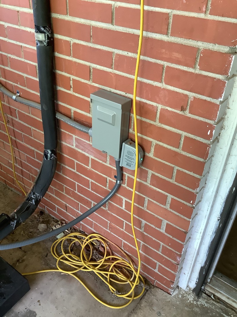 Outdoor AC disconnect switch and refrigerant lines properly installed.