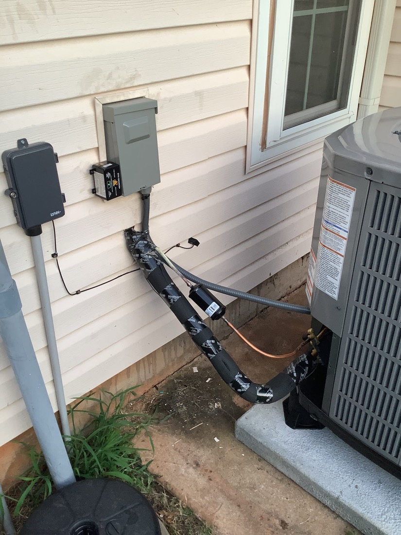 New AC system with disconnect switch and electrical wiring installed
