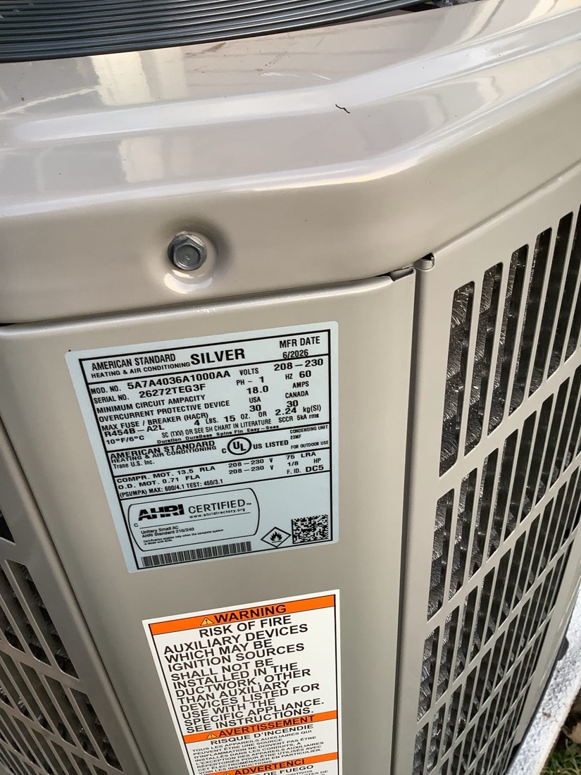 Outdoor AC condenser unit installed beside residential siding