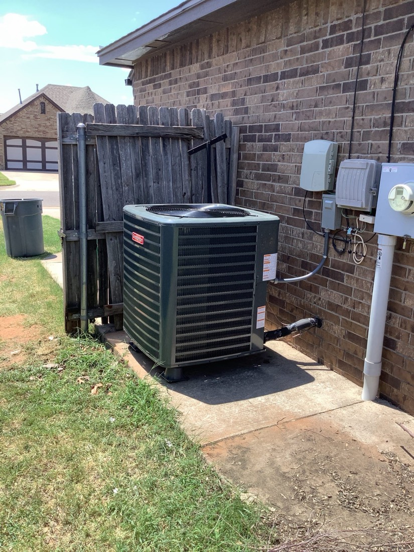 Newly installed air conditioning condenser unit at residential home in Mustang