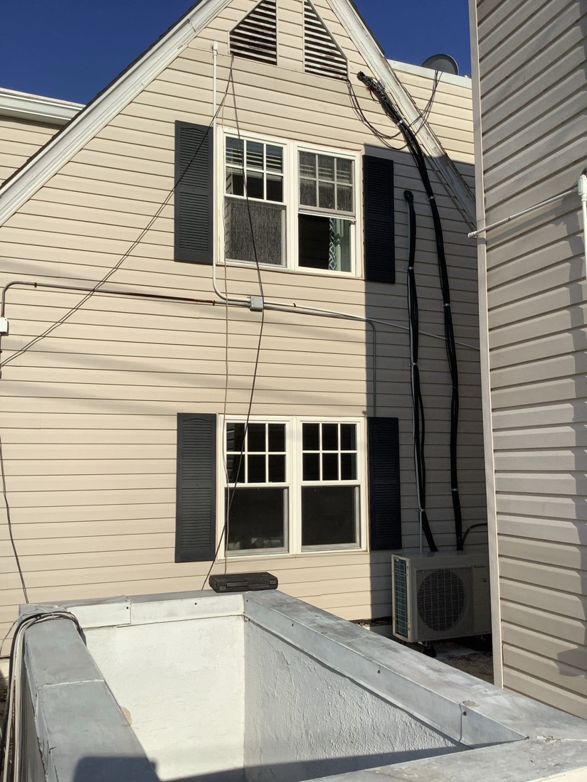 White Daikin air conditioning unit installed outdoors.