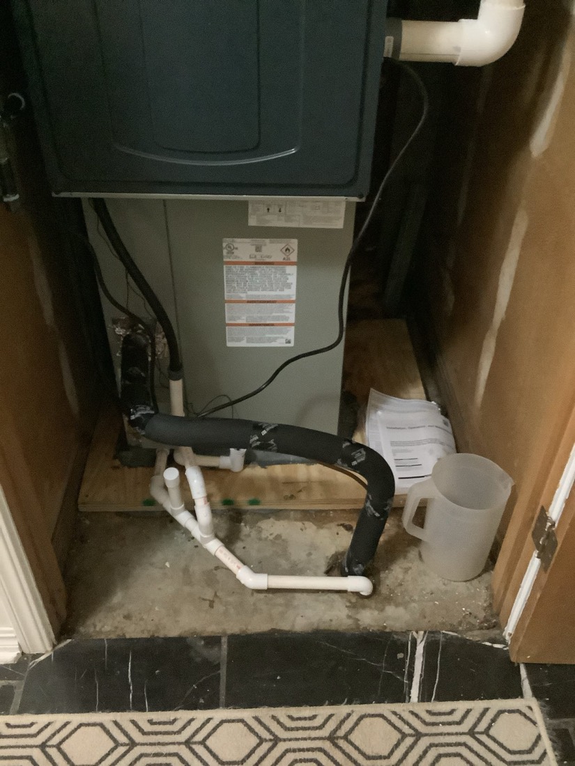 New furnace installation with white PVC piping and condensate drain