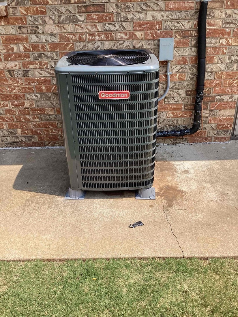 Installed Goodman air conditioner unit with connections