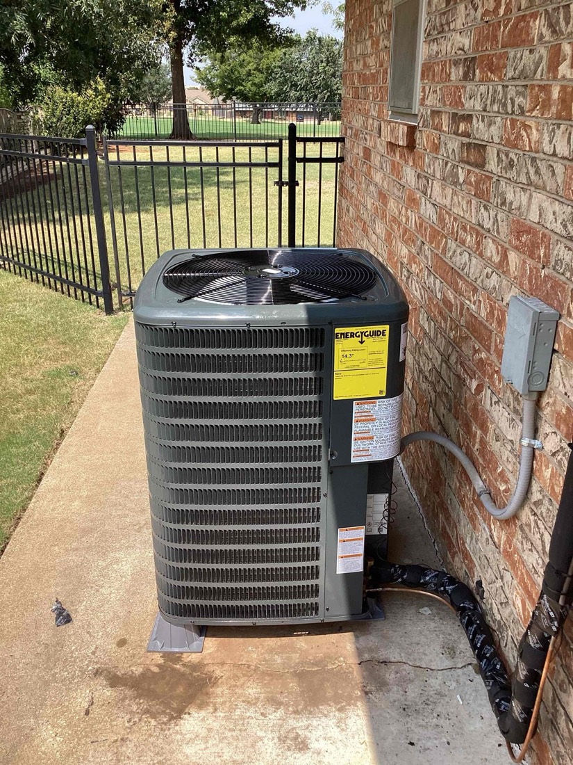 Newly installed AC condenser unit with disconnect switch