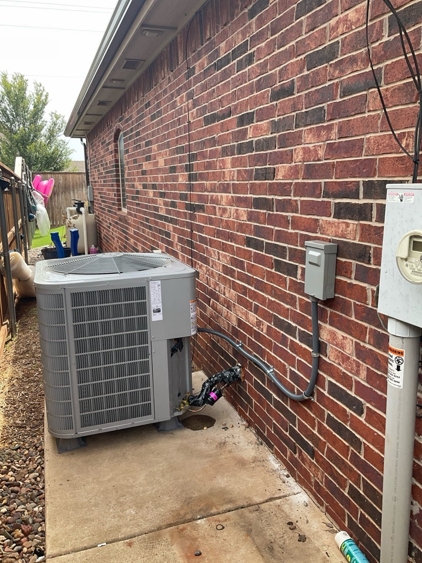 Outdoor AC condenser with properly installed and routed refrigerant connections