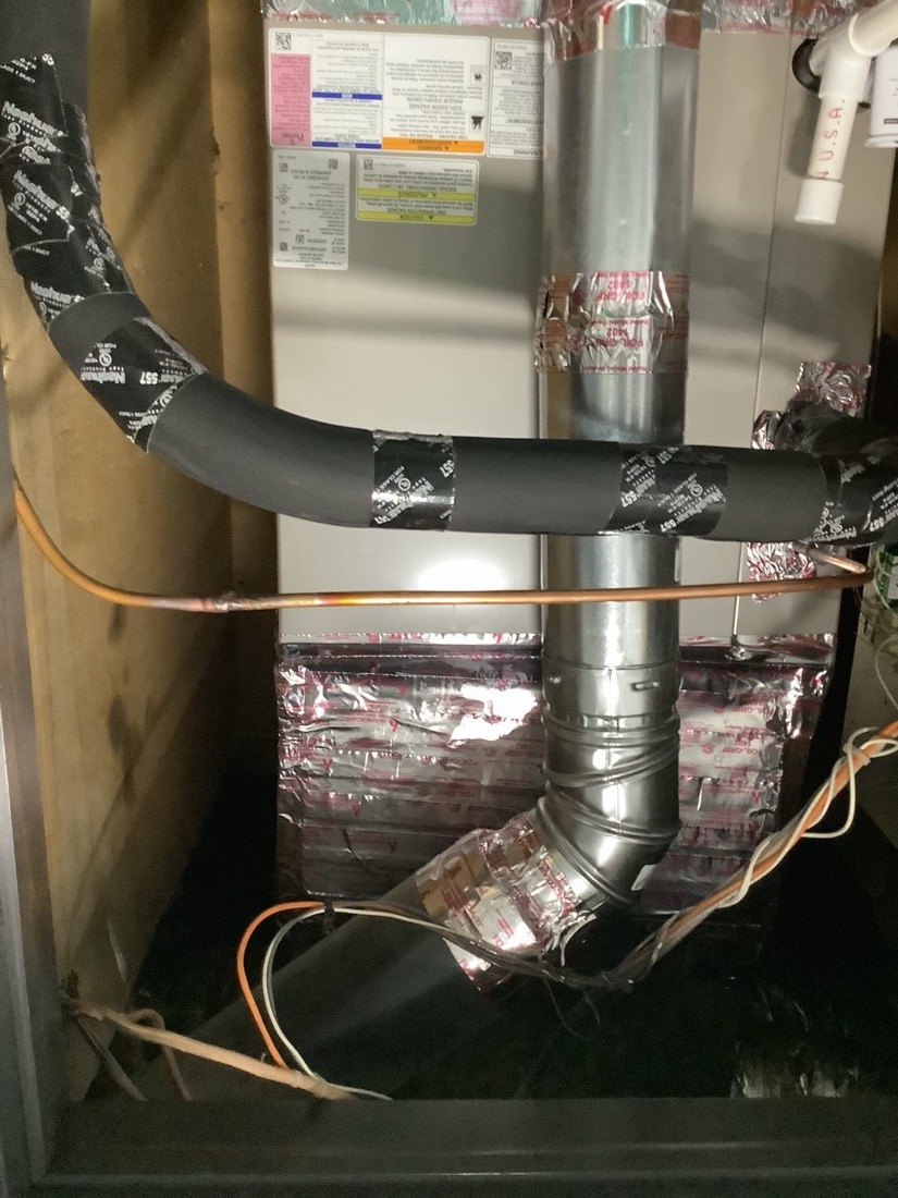 Installed refrigerant lines and ductwork in HVAC system.