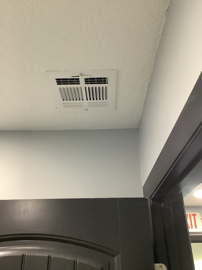 Installed ceiling HVAC air vent in residential space.